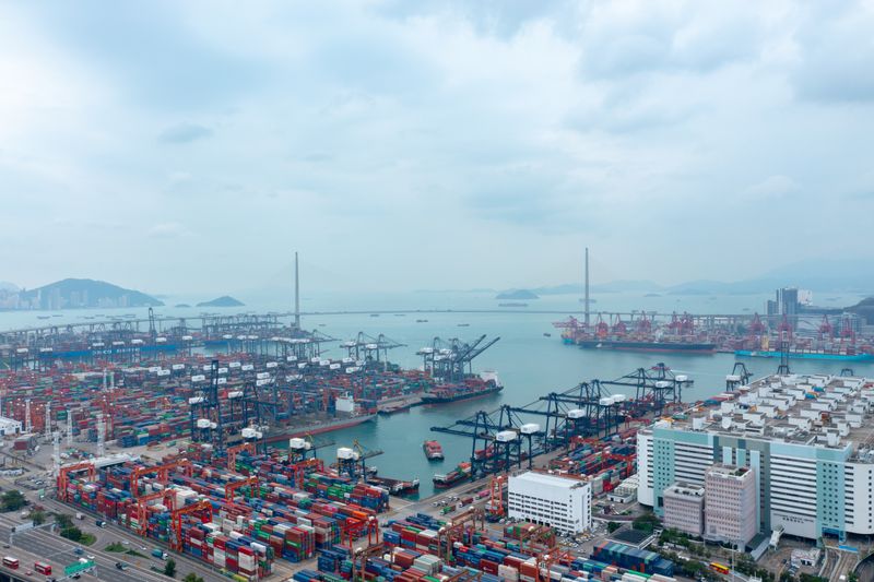 Overhead view of bustling container port in Hong Kong's New Territories, showcasing industrial marine activity