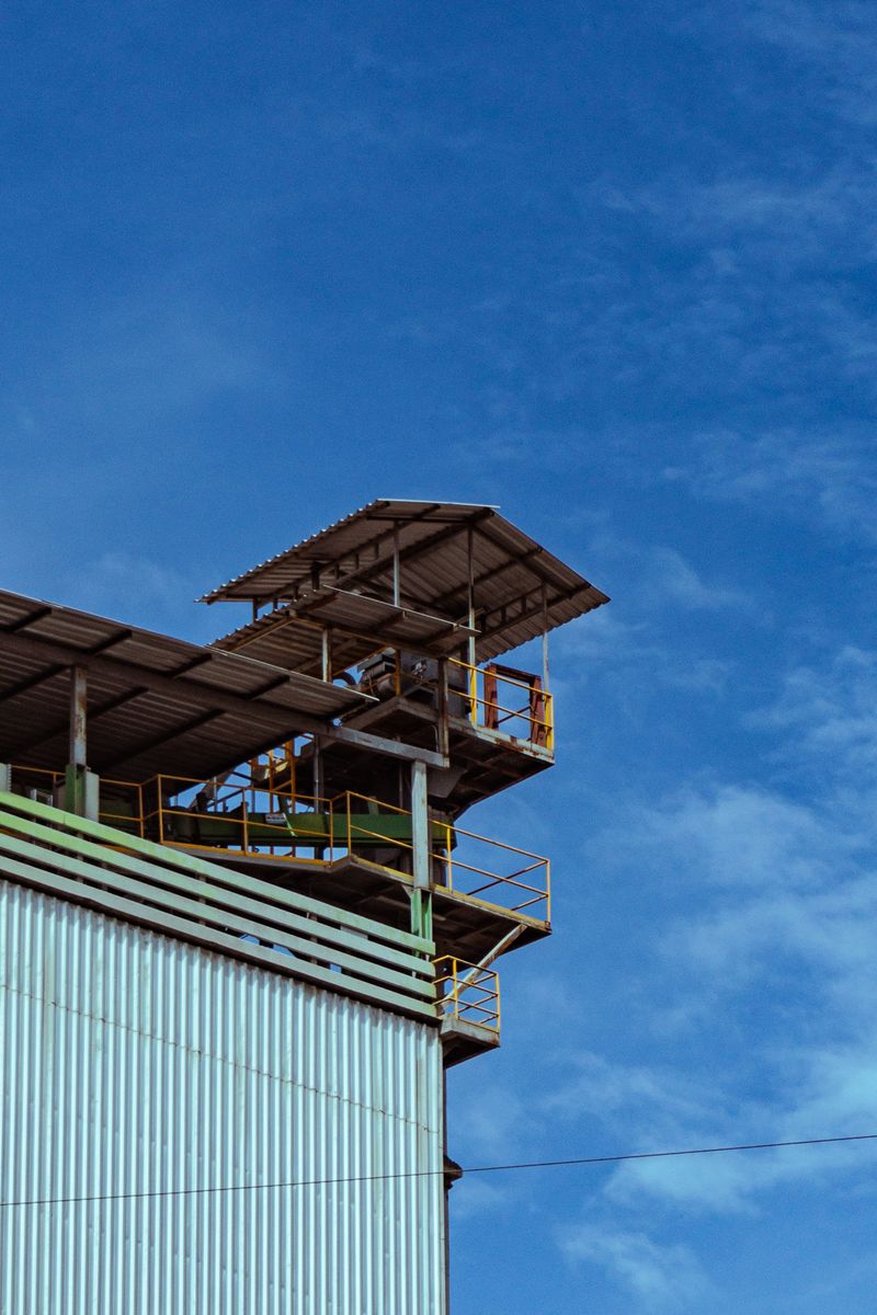 A modern industrial structure with metal siding under a clear sky, showcasing clean lines and architectural design