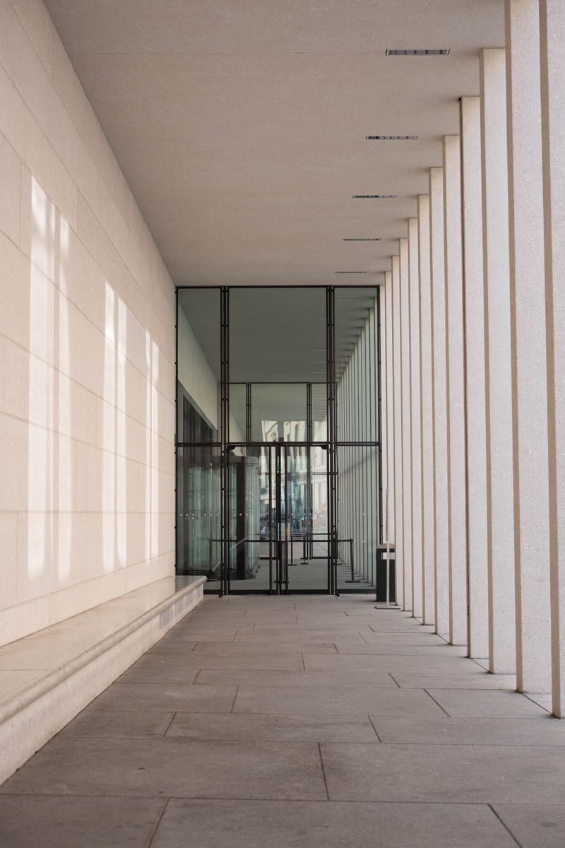 Explore the sleek design of the James Simon Gallery hallway in Berlin, Germany, showcasing modern glass architecture